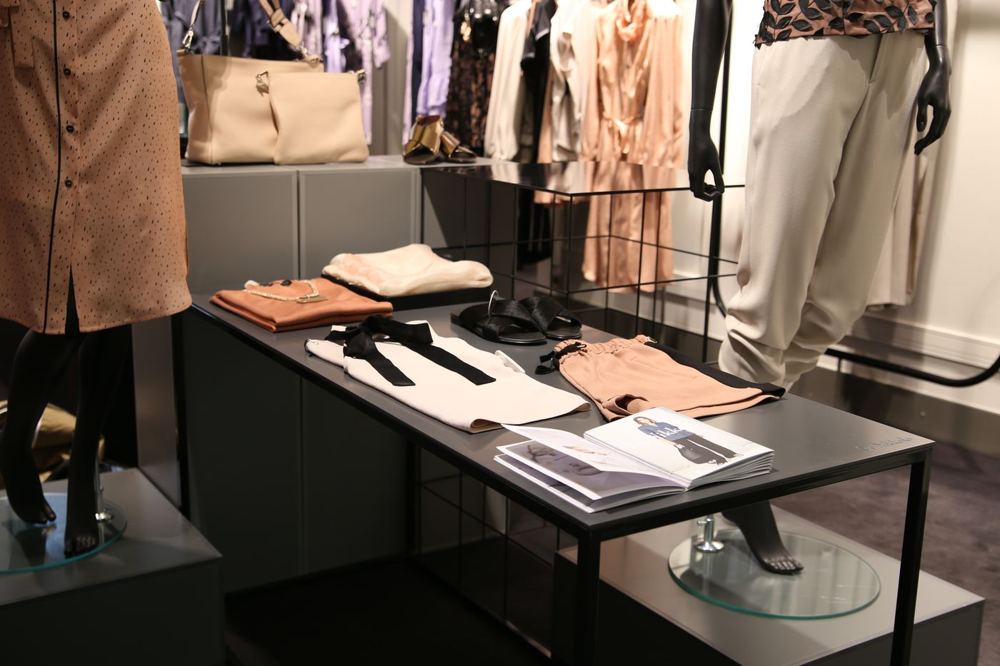 Intérieur de boutique avec présentoirs de vêtements et mannequins