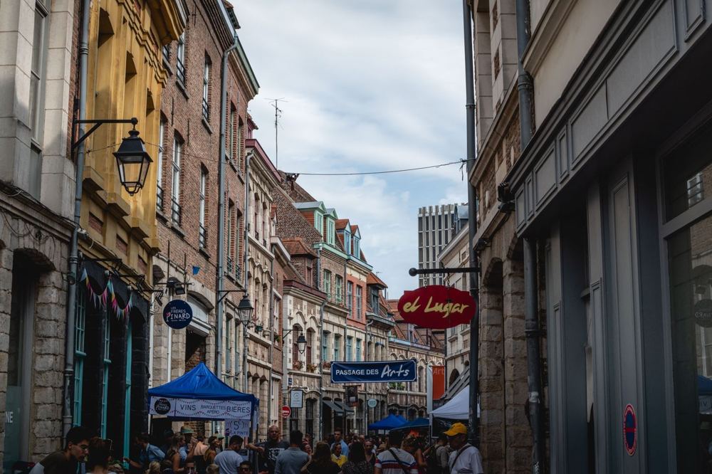Rue animée de Lille avec architecture historique et enseignes visibles