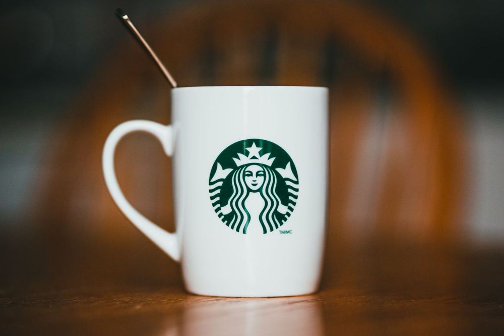 Mug en céramique blanc avec logo de marque et boisson chaude